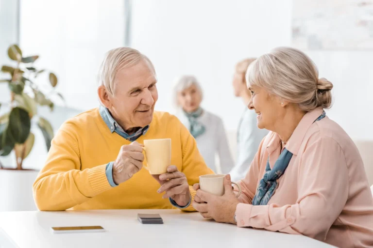 Smiling Senior Man and Woman having Tea
