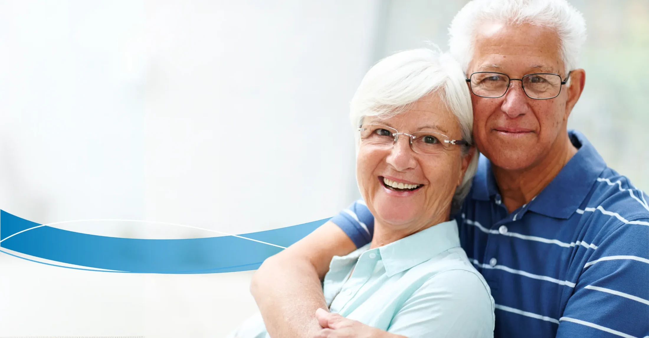 Older couple with blurred outdoor background happy
