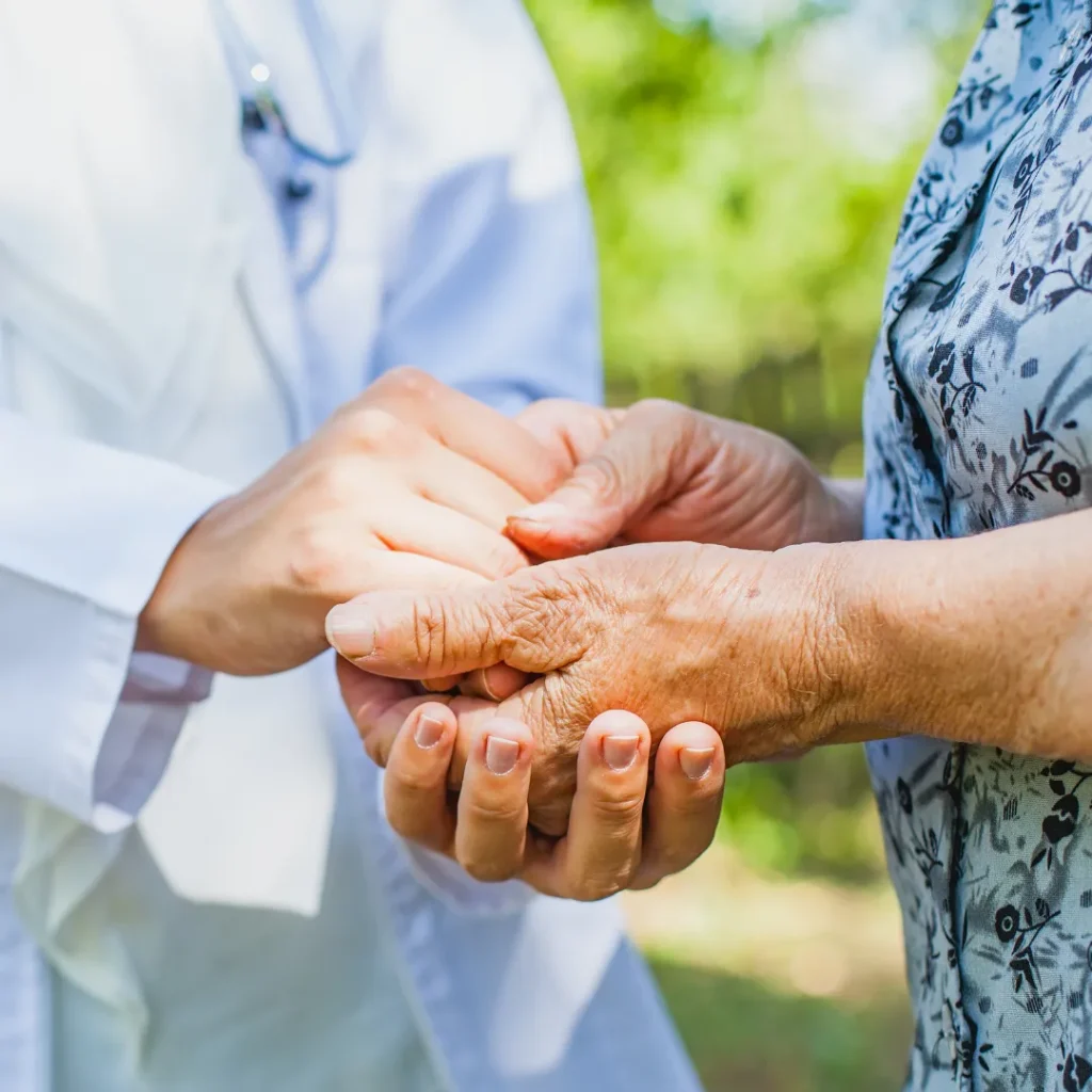Doctor holding hands of patient