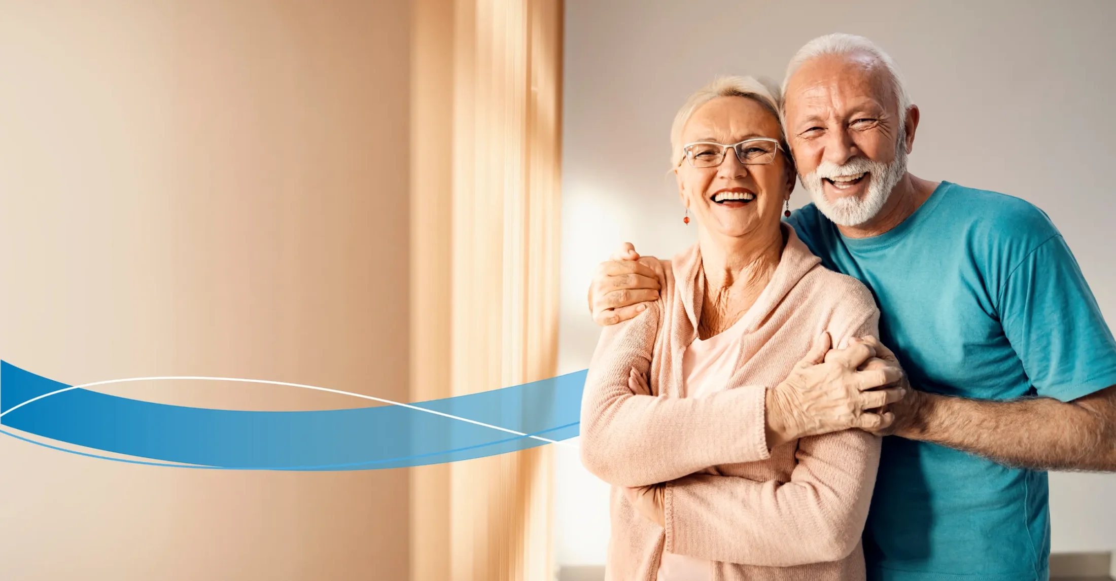 Older couple standing happy with blurred interior in background