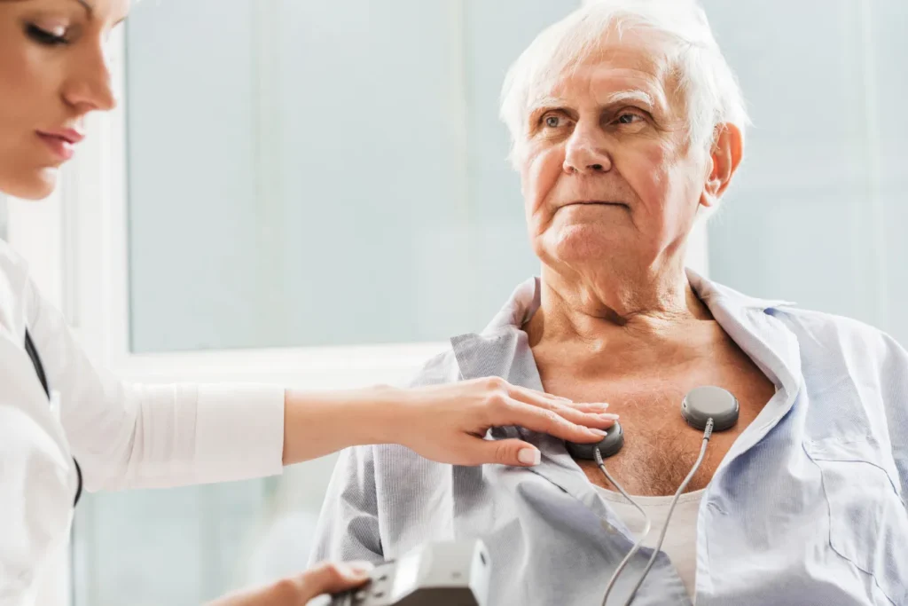 Doctor assisting elderly man with a medical test