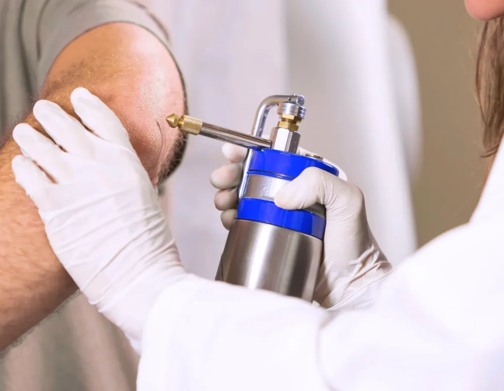 Physician assisting patient with dermatology procedure